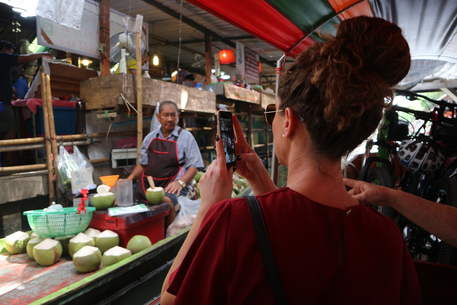 Women uses her Camera Phone on a boat at Khlong Lat Mayom Floating Market